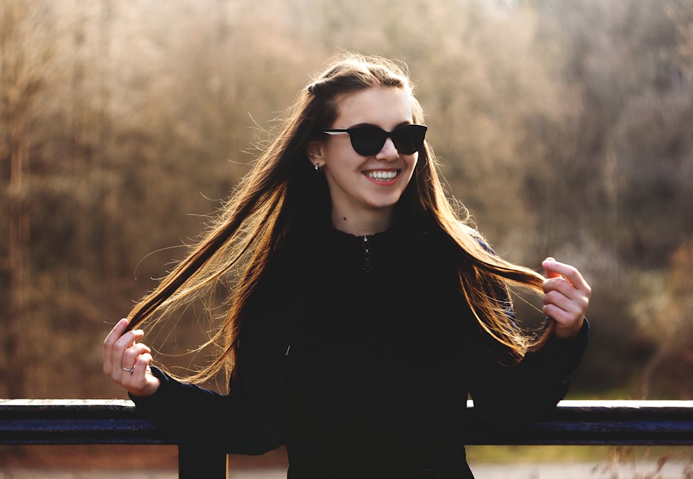 woman in black long sleeve shirt wearing black sunglasses