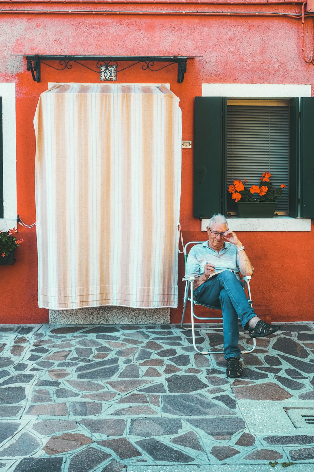 man in blue denim jeans sitting on chair