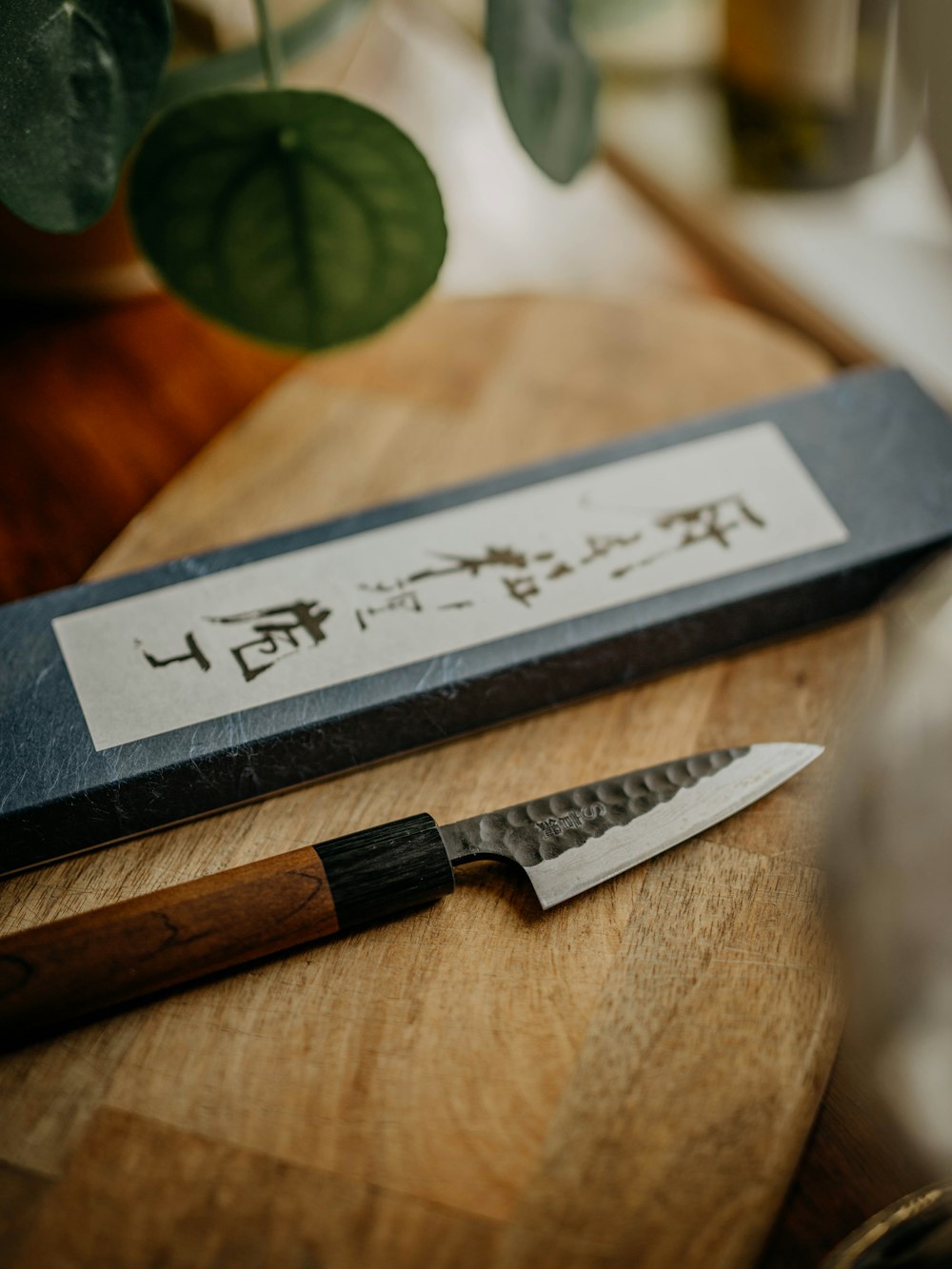 black and silver knife on brown wooden chopping board