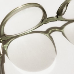 black framed eyeglasses on white surface