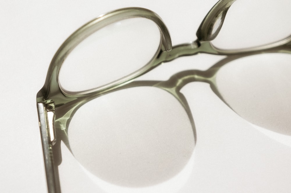 black framed eyeglasses on white surface