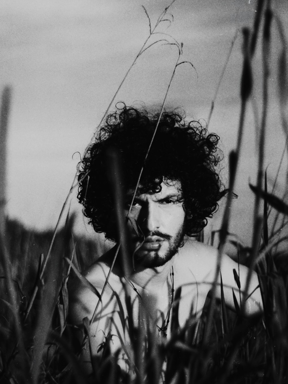 grayscale photo of woman in grass field