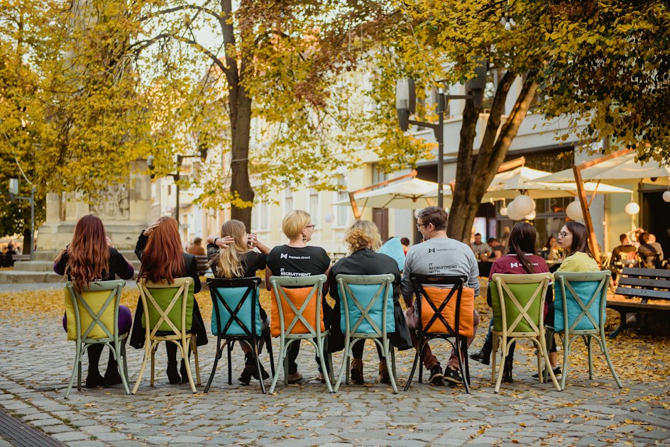 People sitting on chairs under a tree during the day