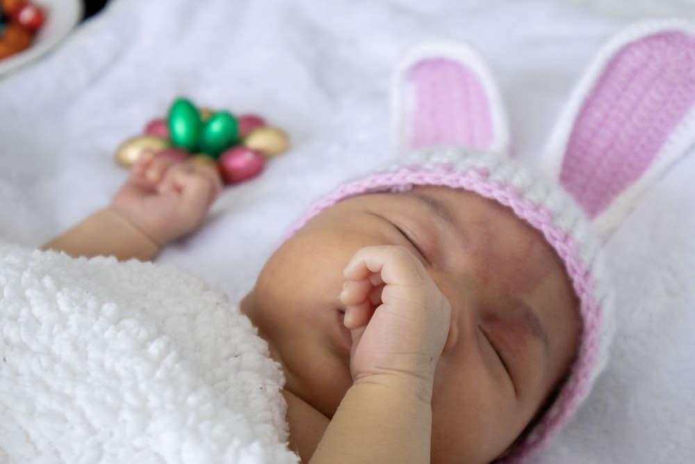 baby in pink knit cap