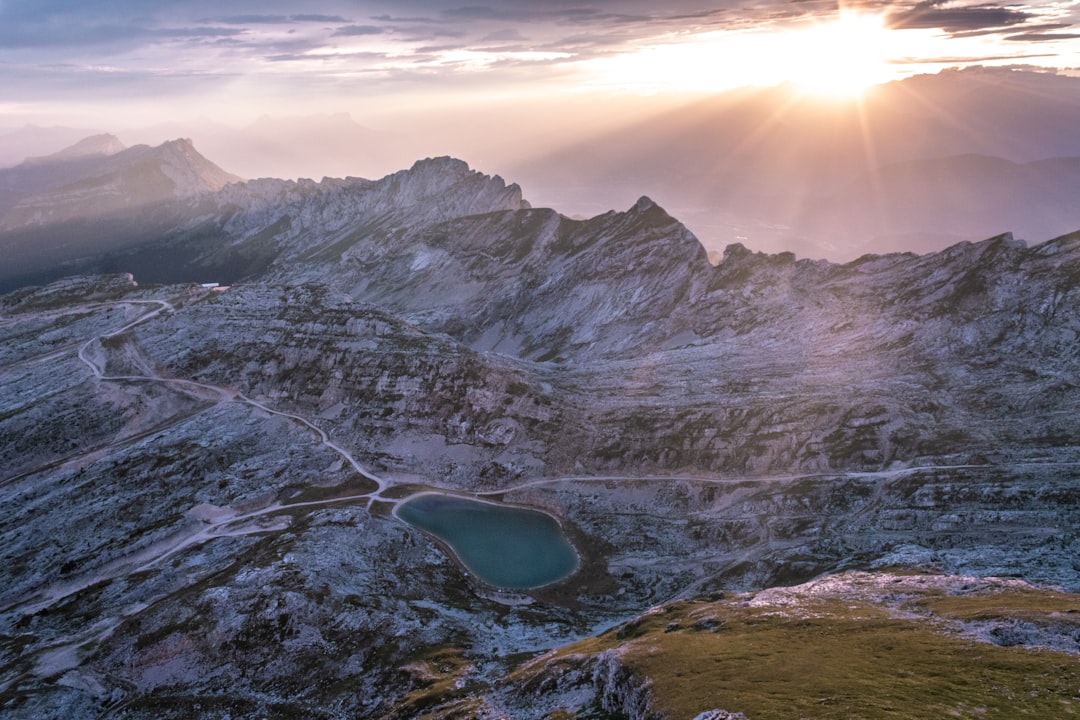 lake in the middle of mountains during daytime