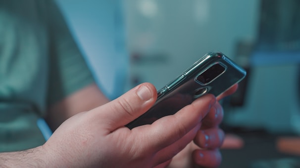 A person using a sleek smartphone with clear call quality in a bright, modern environment.