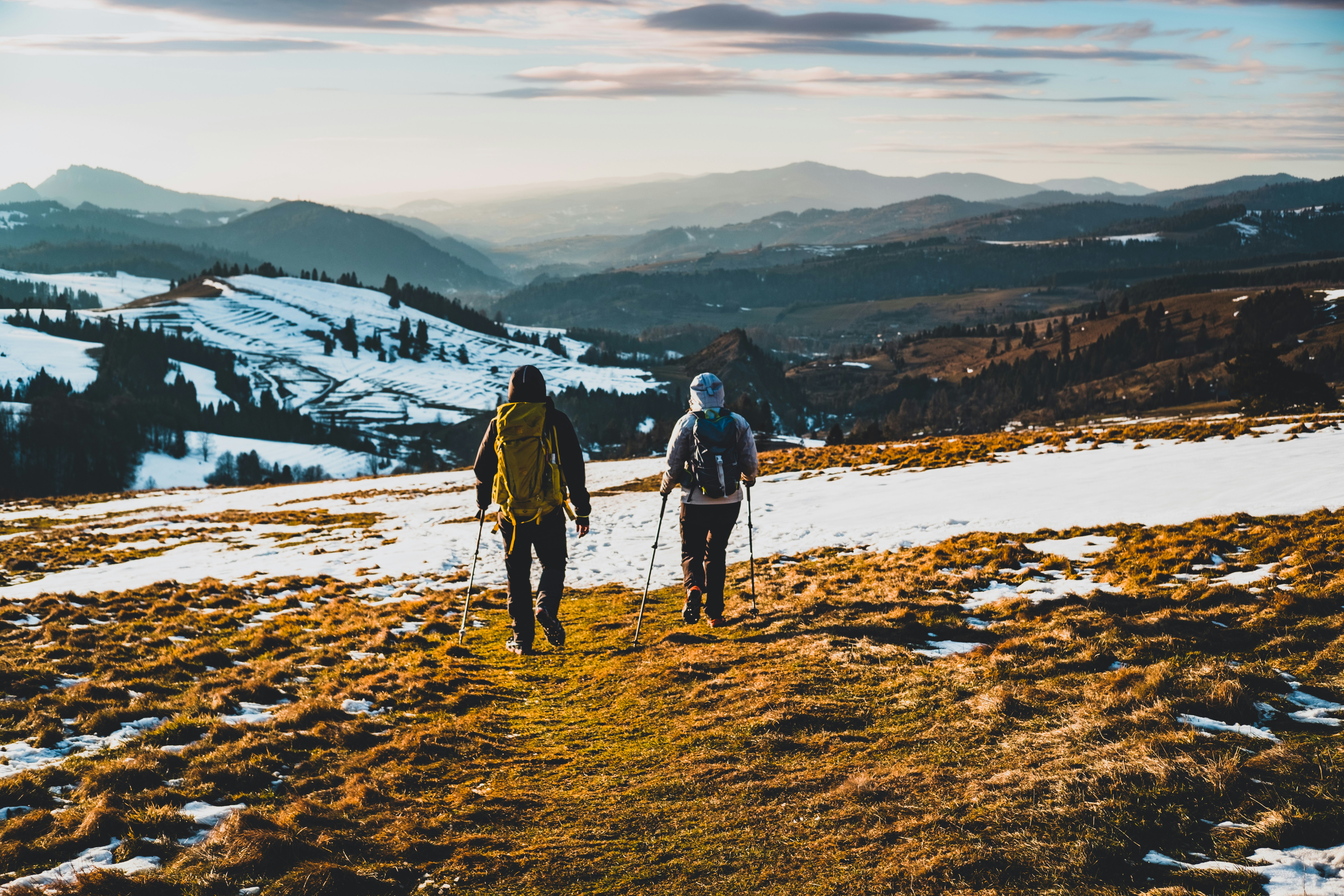 2 men walking on snow covered ground during daytime, 