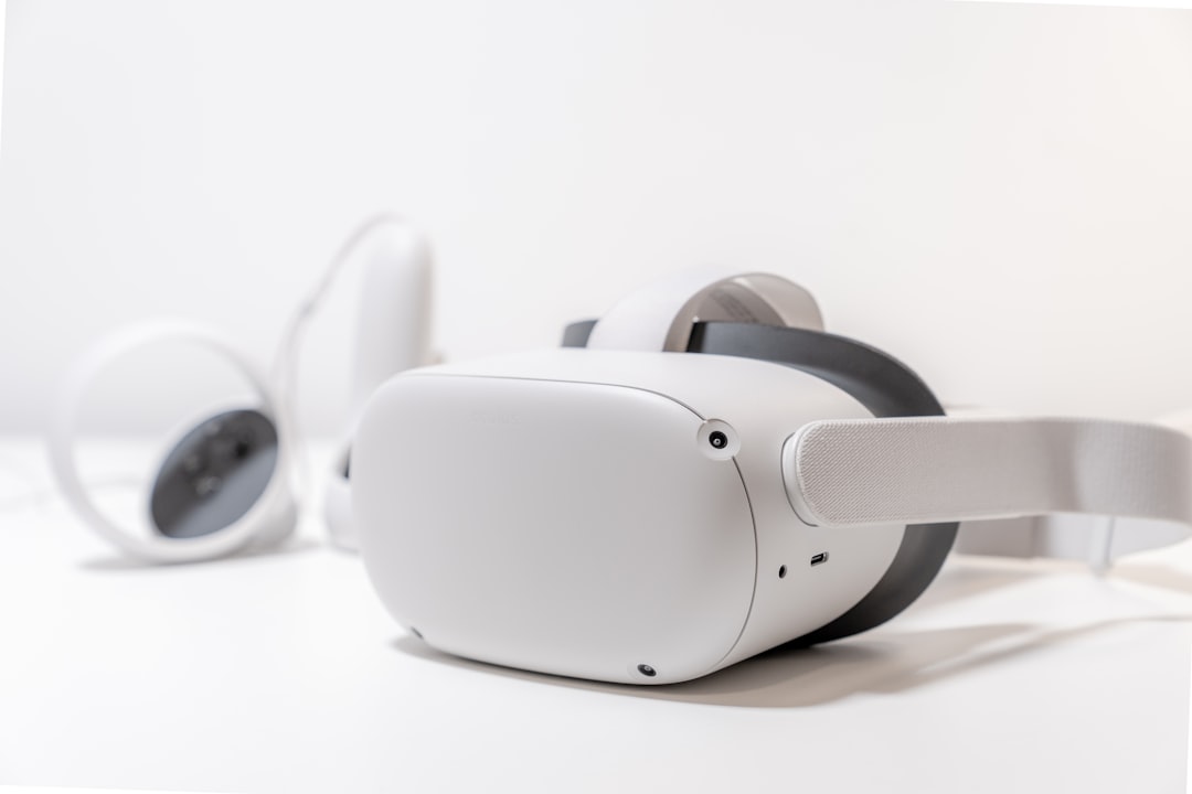 white and black beats by dr dre headphones, oculus quest 2 on white desk with lamp