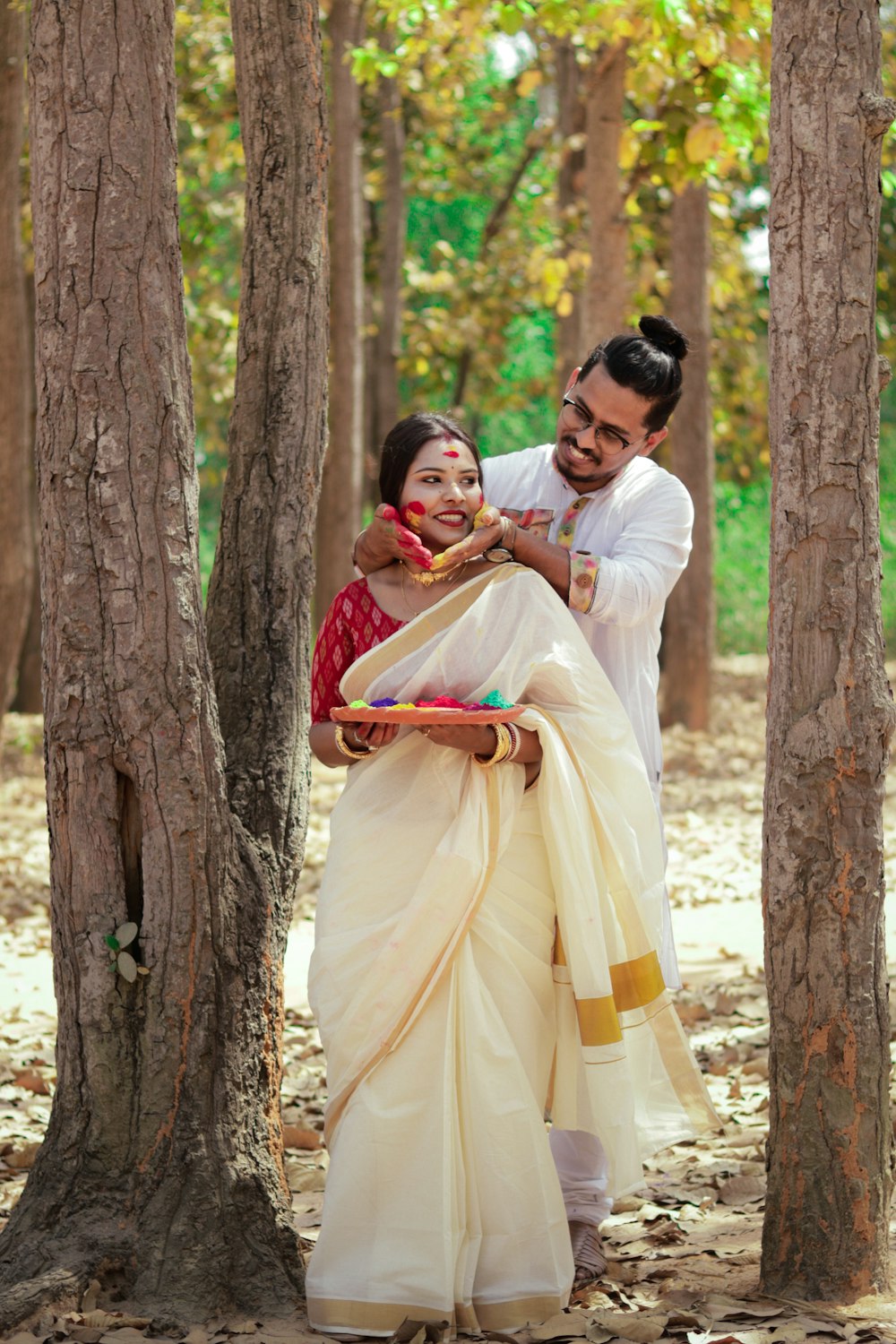 man in white dress shirt kissing woman in yellow dress