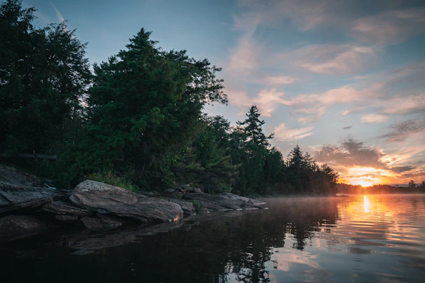 A serene lakeside scene at sunset symbolizing peaceful retirement planning.