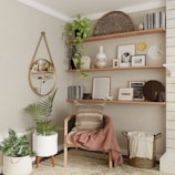 A warm living room corner featuring a soft throw blanket and rustic wooden shelves with small plants.