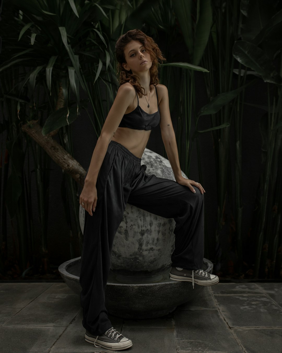 woman in black and white skirt sitting on black round seat