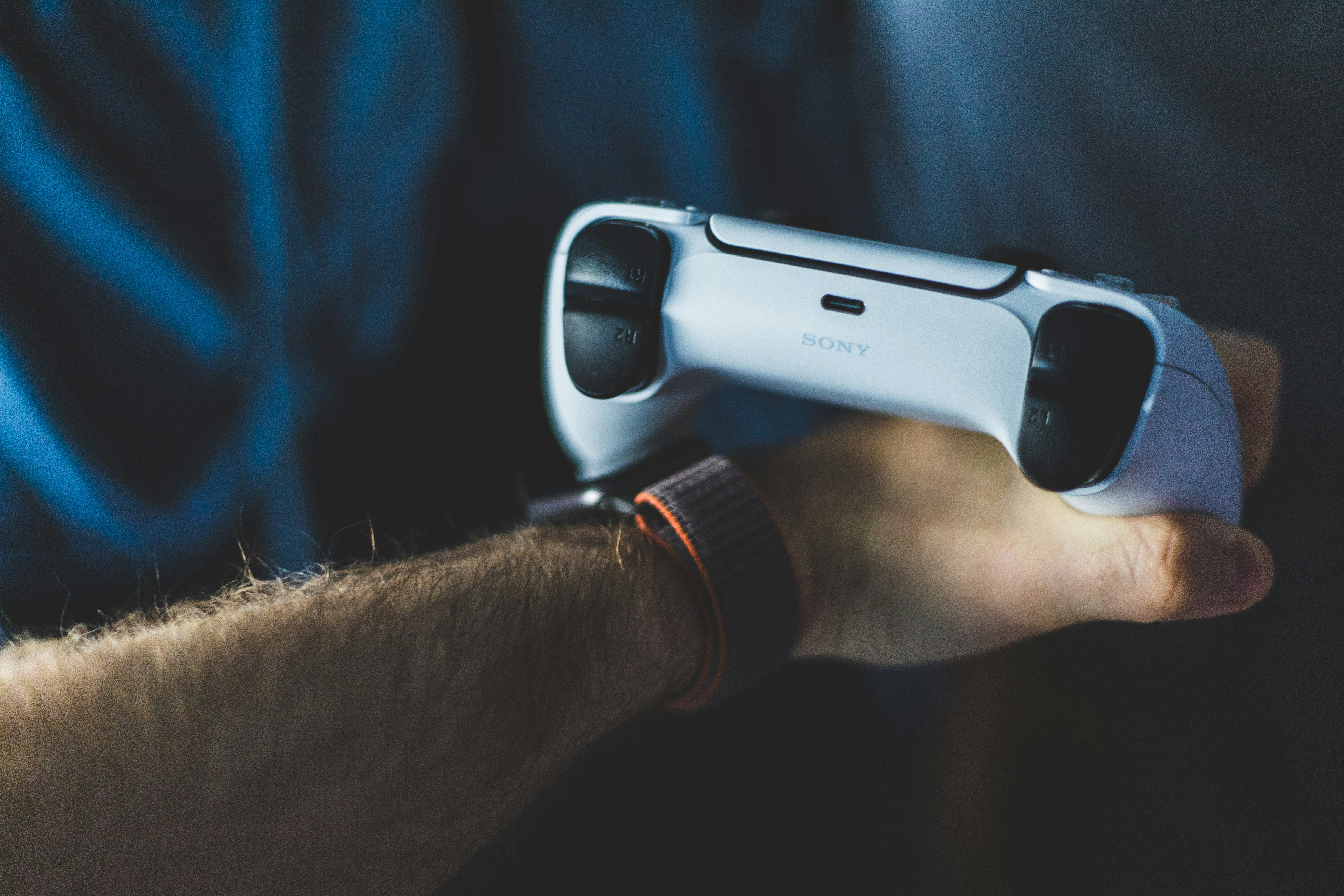 person holding black and white game controller, 