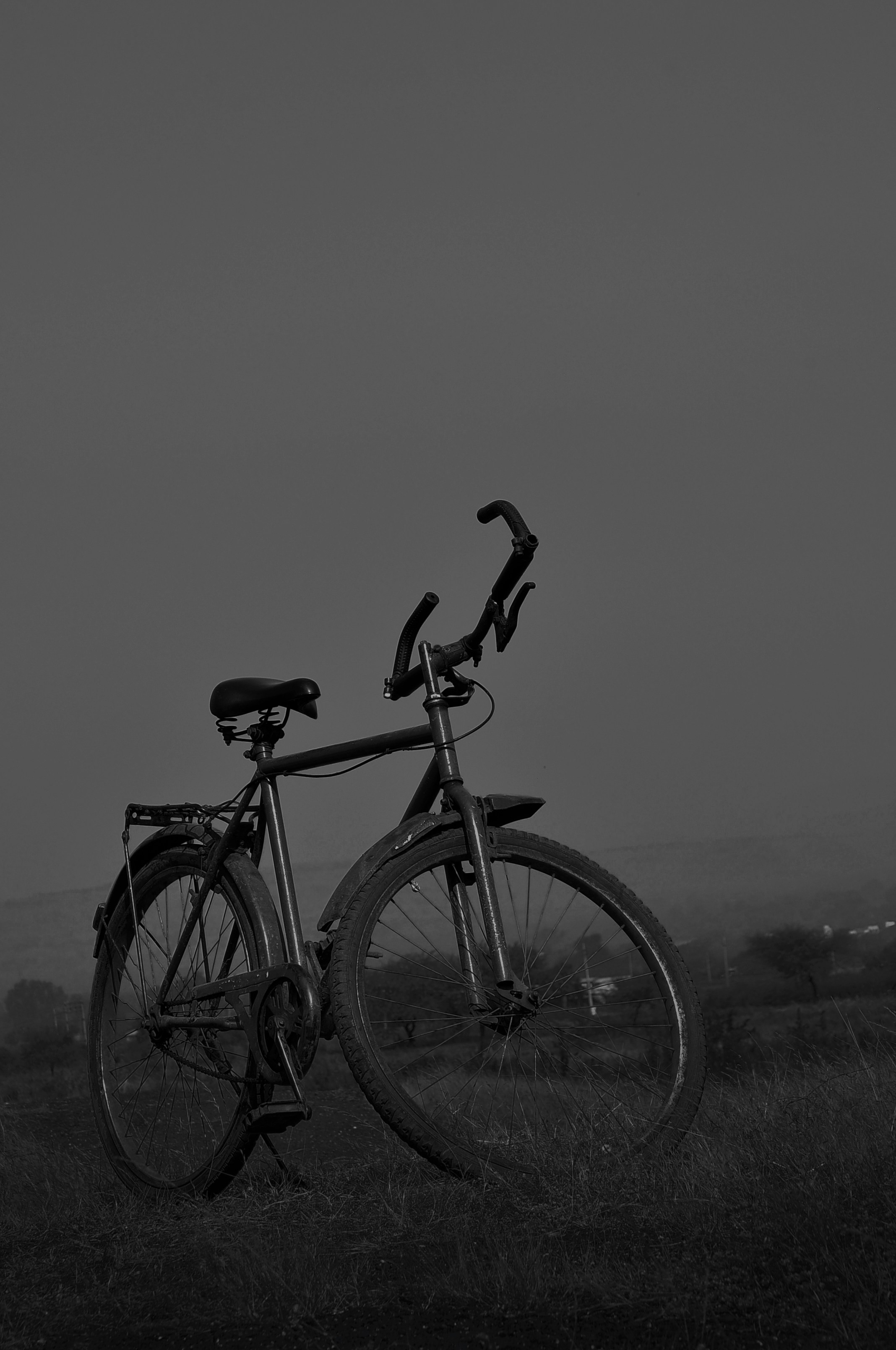 grayscale photo of person riding on bicycle