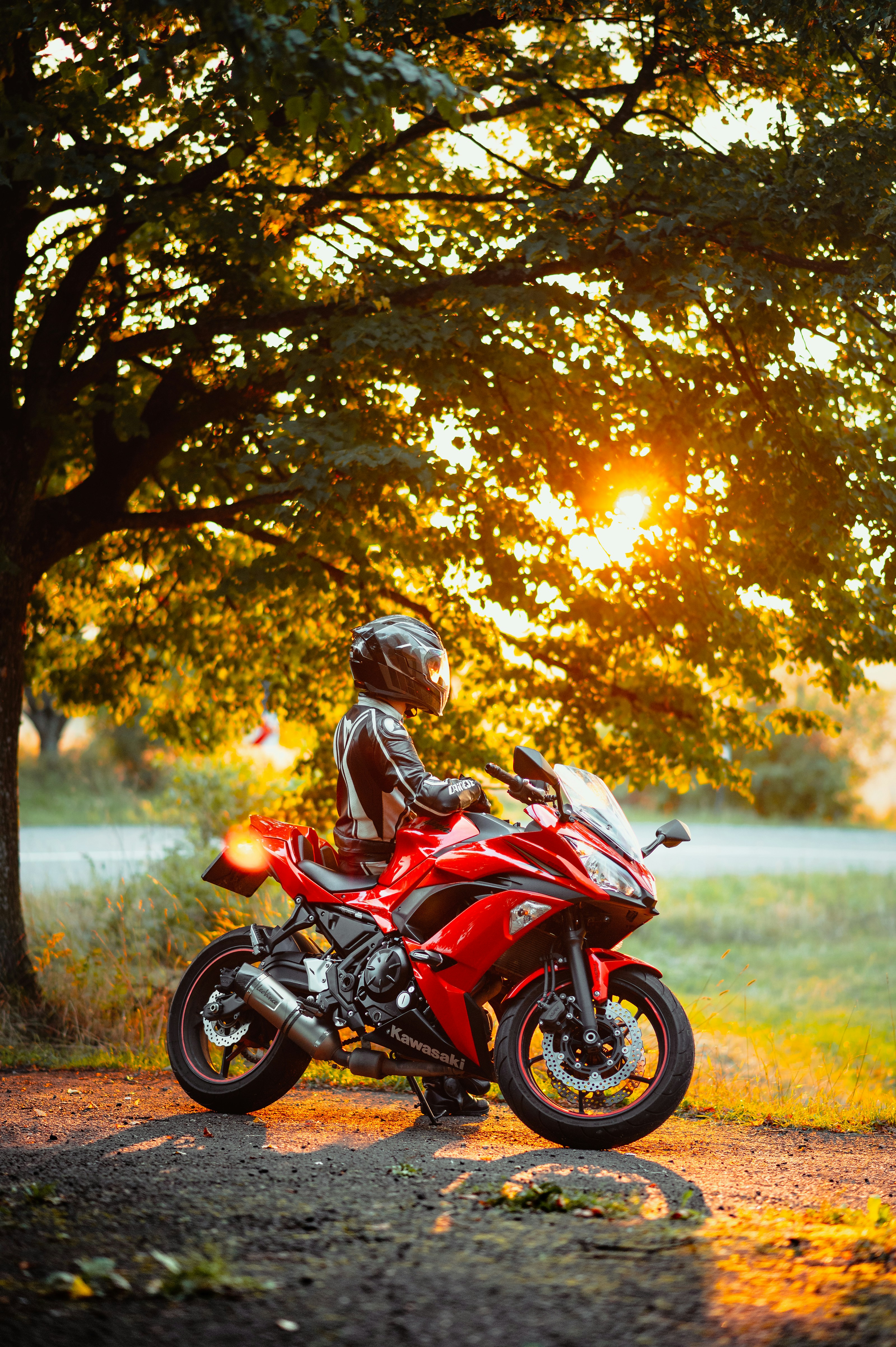 Man in red and black motorcycle helmet riding red and black ...