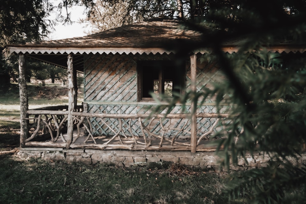 white and brown wooden house near green trees during daytime