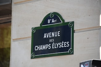 a sign on the side of a building that says avenue des champs elysees
