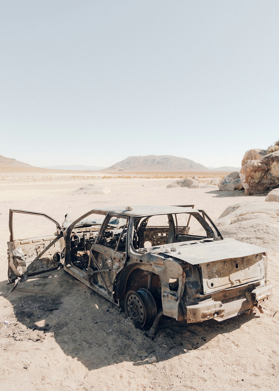 black and white car on brown sand during daytime