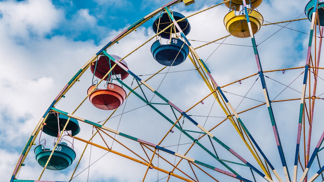 red and blue ferris wheel under blue sky during daytime