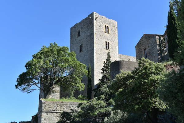 A stone tower among the trees — Collioure, France