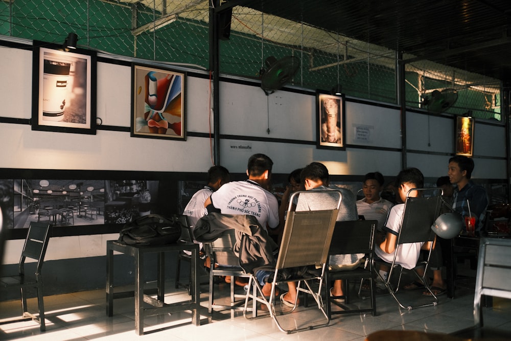 people sitting on chairs inside classroom