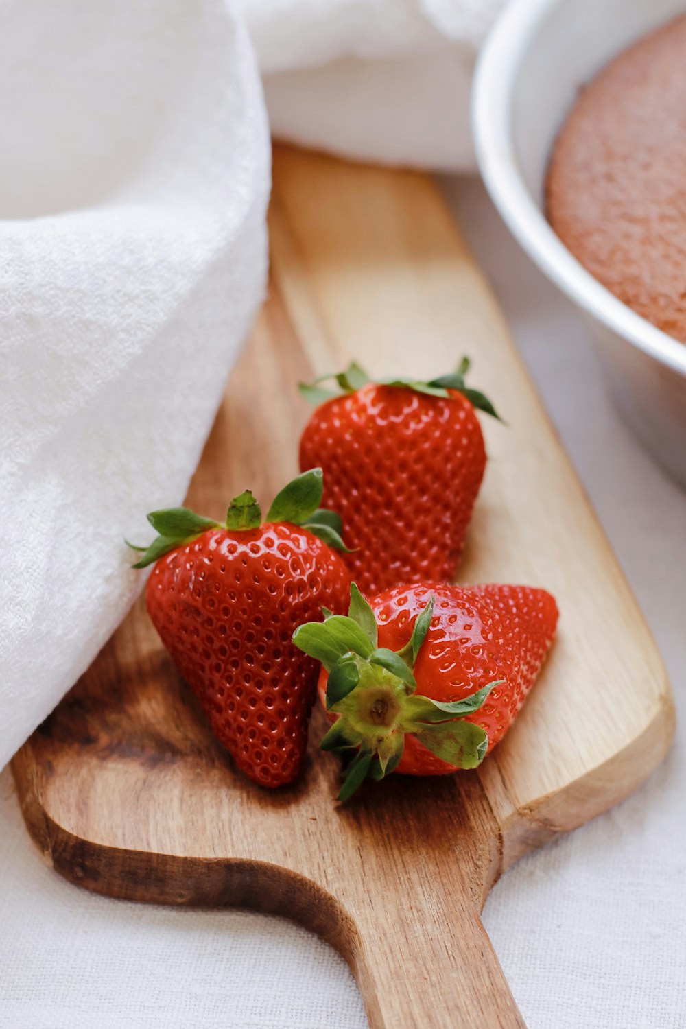 red strawberries on brown wooden chopping board