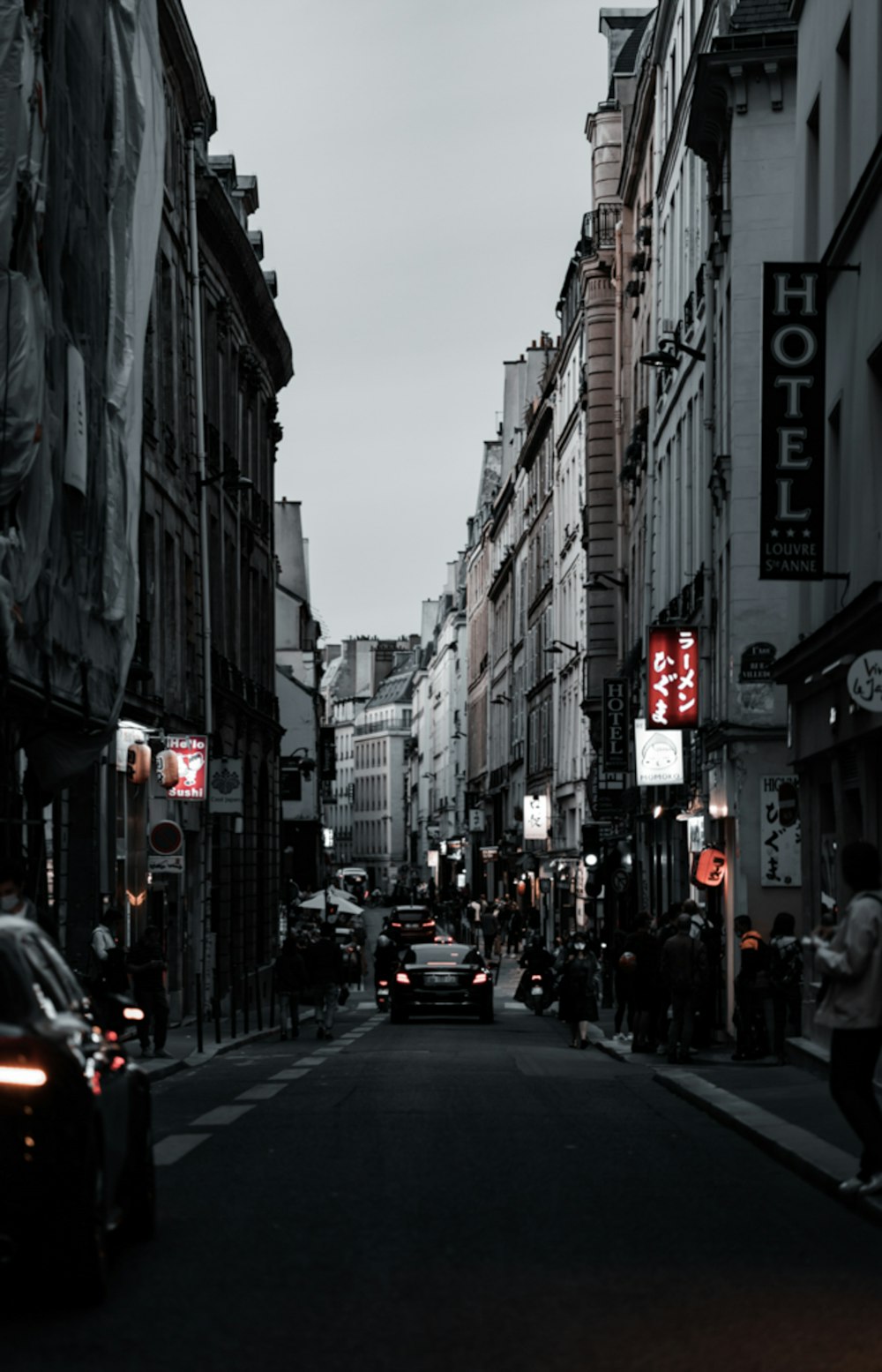 cars on road between buildings during daytime