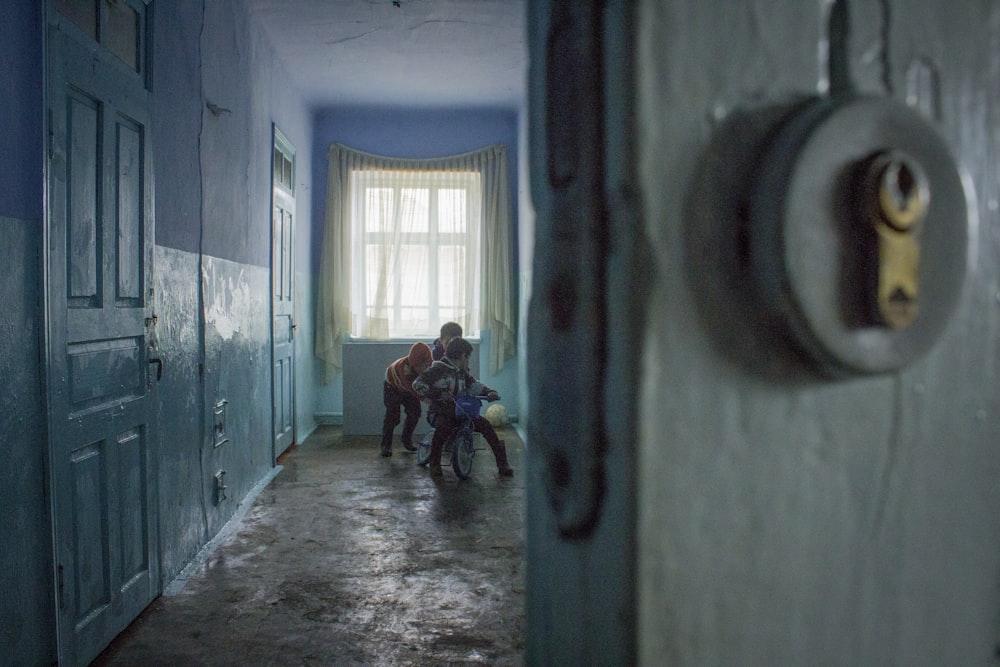 2 people sitting on chair in hallway