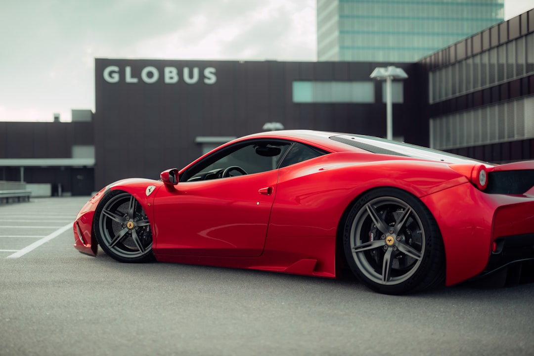 red ferrari 458 italia parked on gray pavement