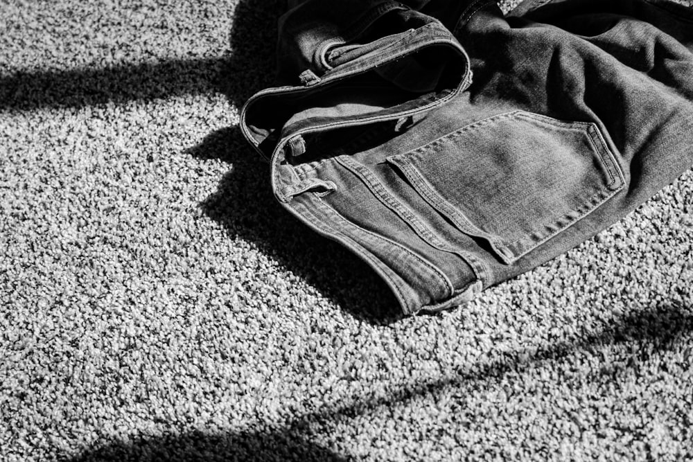 gray denim jeans on gray textile