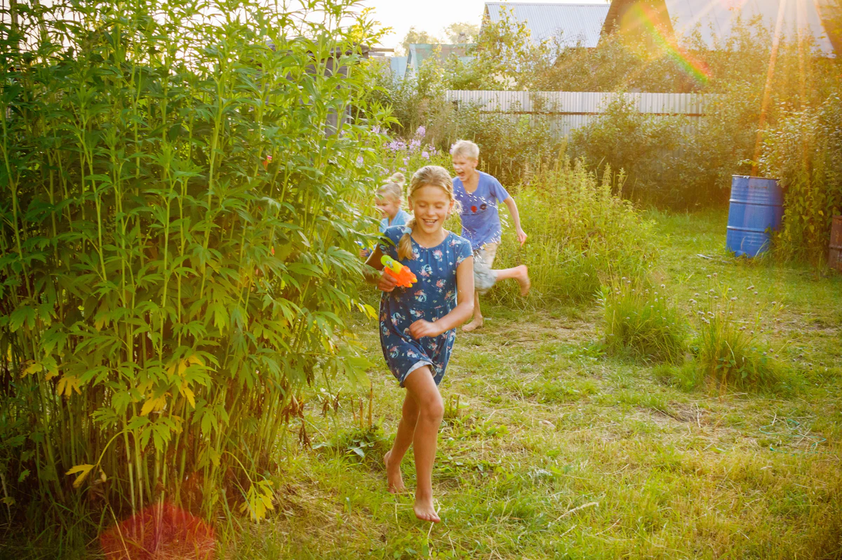 Children running and playing on a green lawn