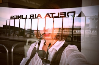 woman in white long sleeve shirt wearing white earbuds