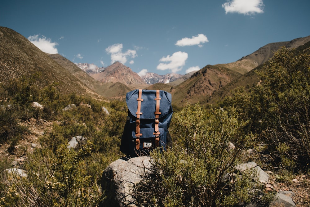 man in blue jacket and blue denim jeans with black and orange hiking backpack standing on on on on on