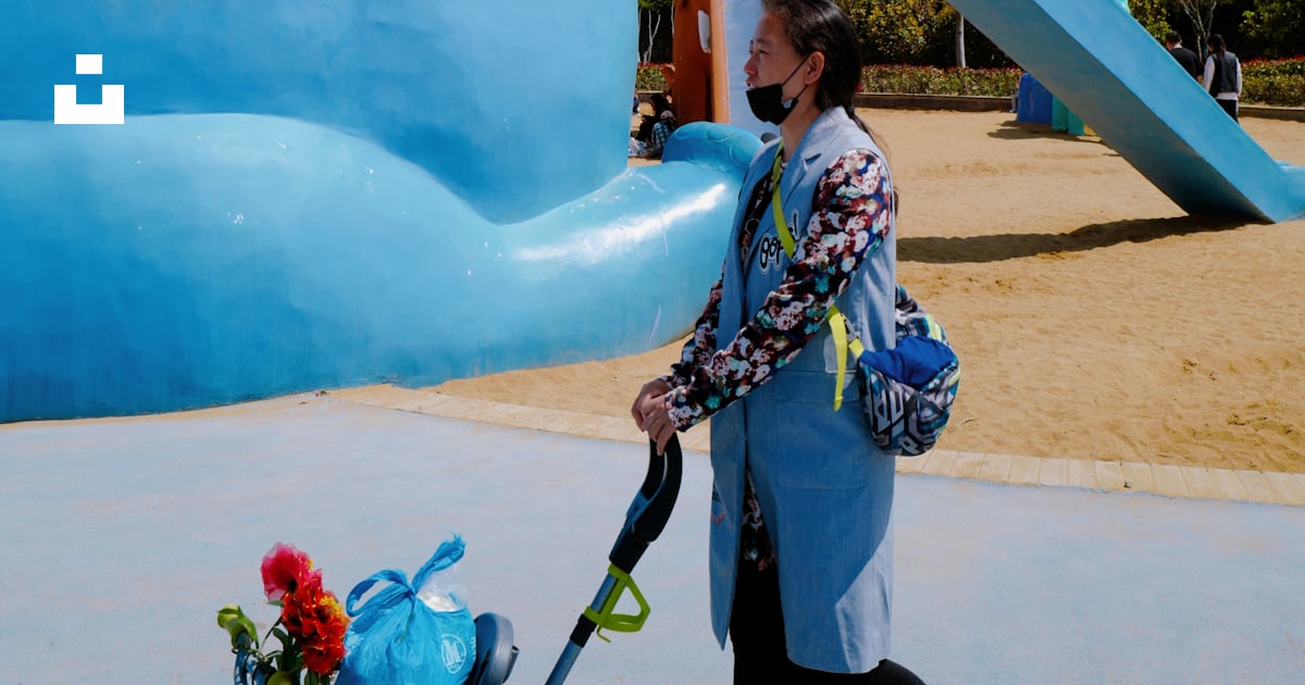 Man in blue and white plaid shirt sitting on blue inflatable inflatable ...