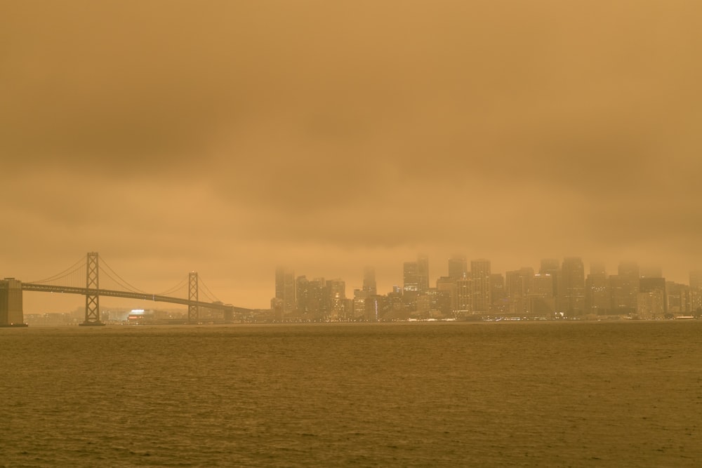 city skyline across bridge during daytime