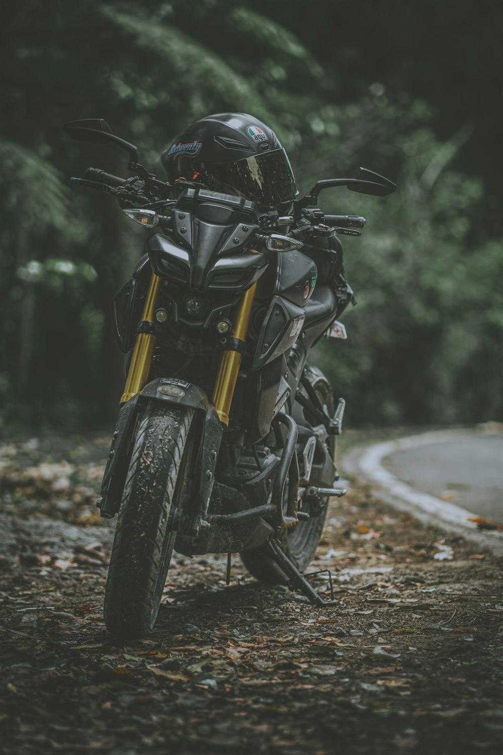 black and yellow motorcycle parked on the road