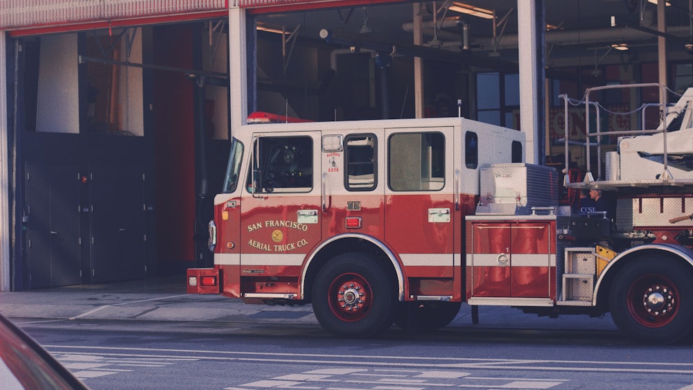 red and white fire truck on road during daytime