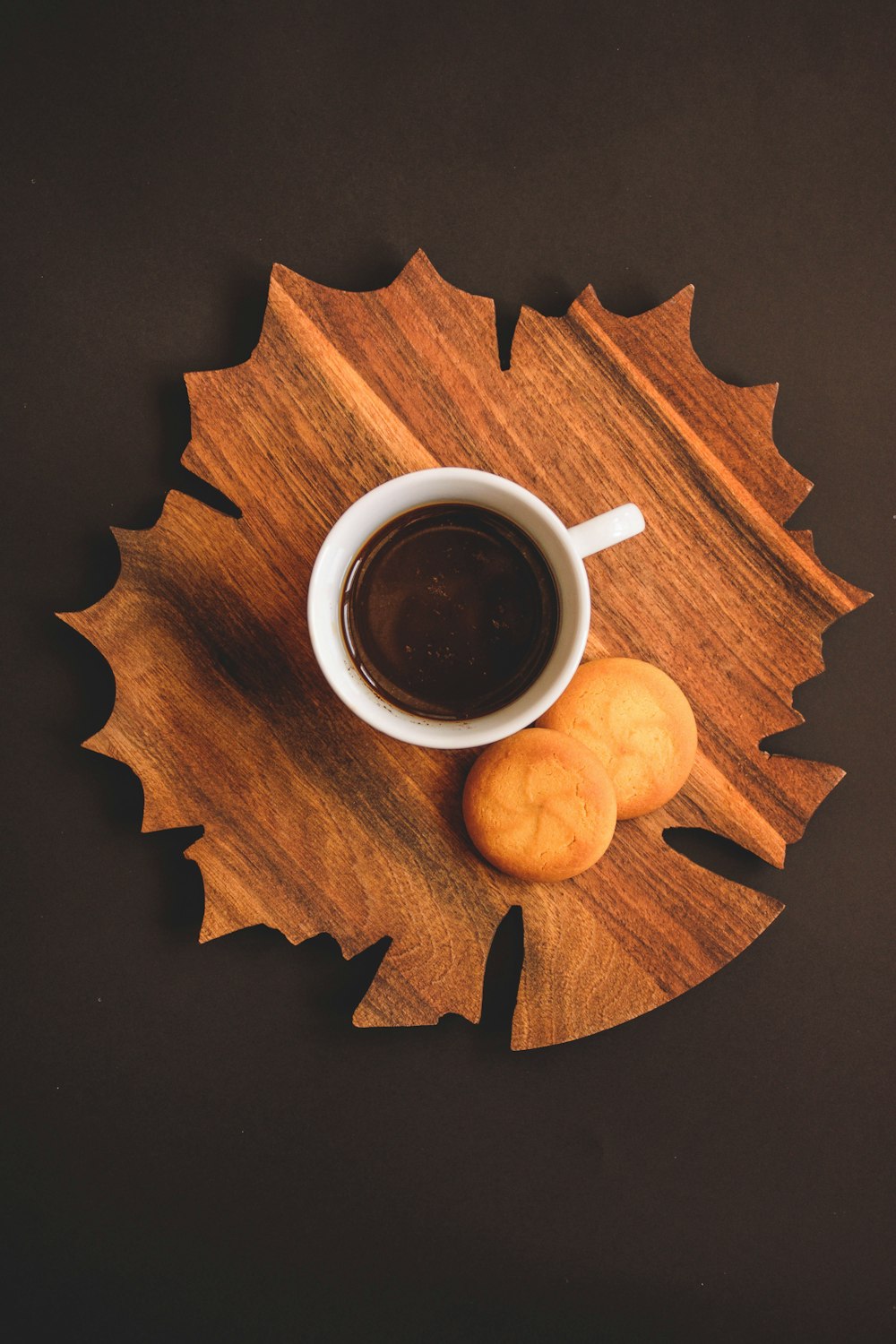 white ceramic mug on brown wooden table