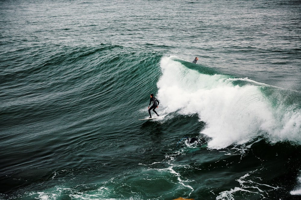 person surfing on sea waves during daytime
