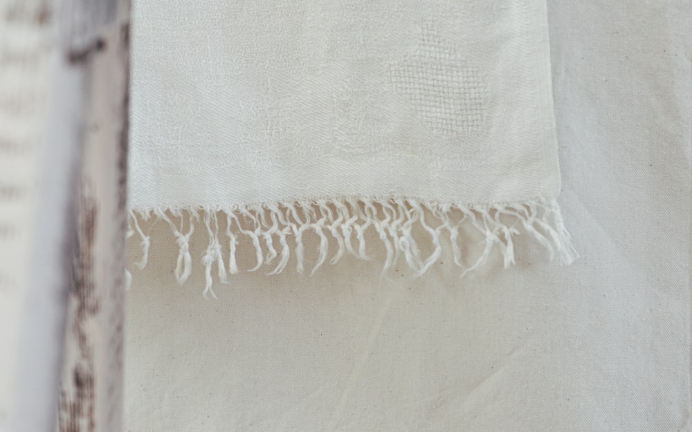 white textile on white textile