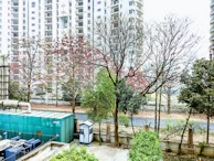 Exterior view of a commercial property adapted for emergency housing, surrounded by greenery.