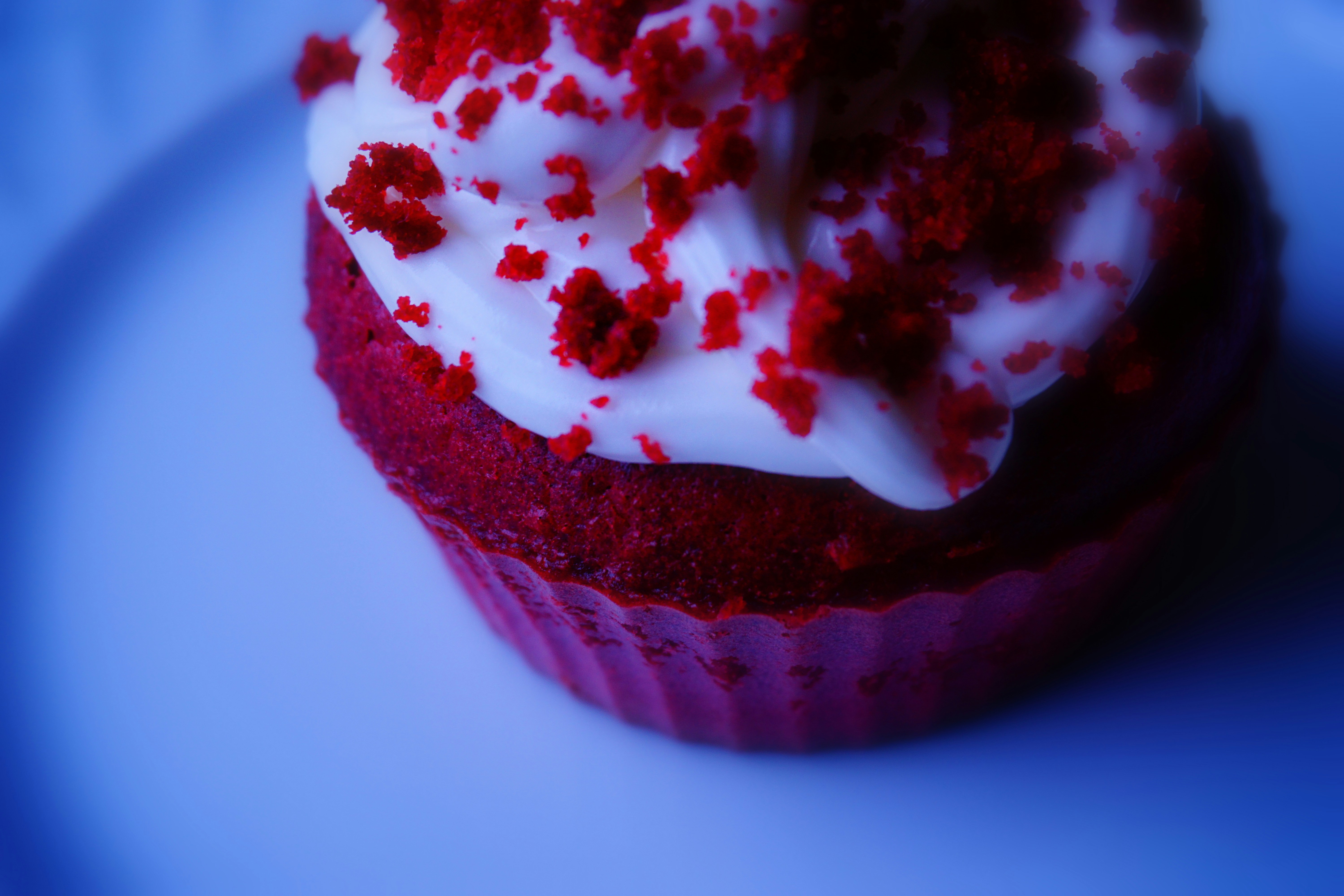 Cupcake cross-section showing moist red velvet interior with cream filling