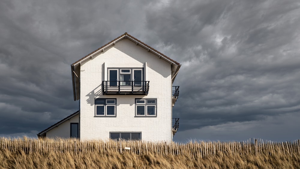 white and black house under gray clouds