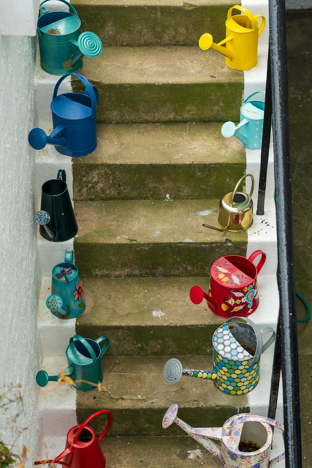 blue plastic bucket on gray concrete stairs