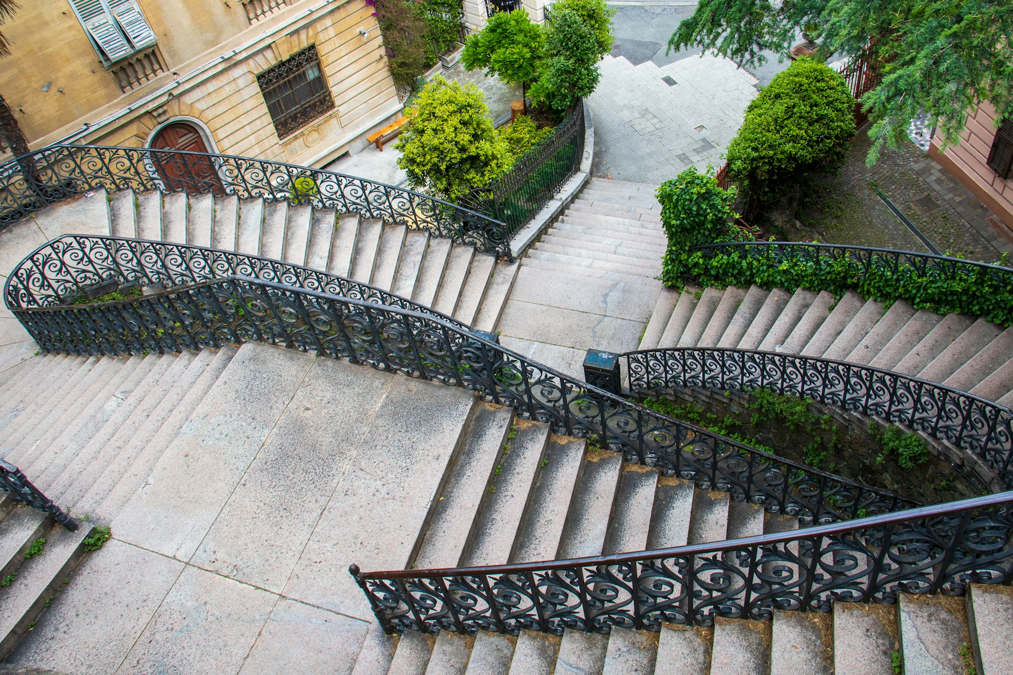 Decorative railings on stairs leading down into Genova, Italy.