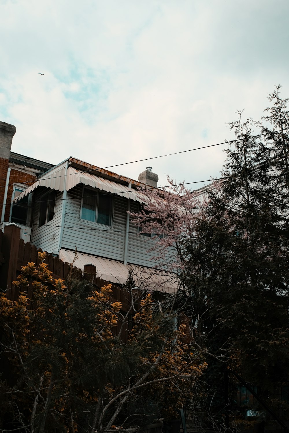 white and brown wooden house under white clouds during daytime