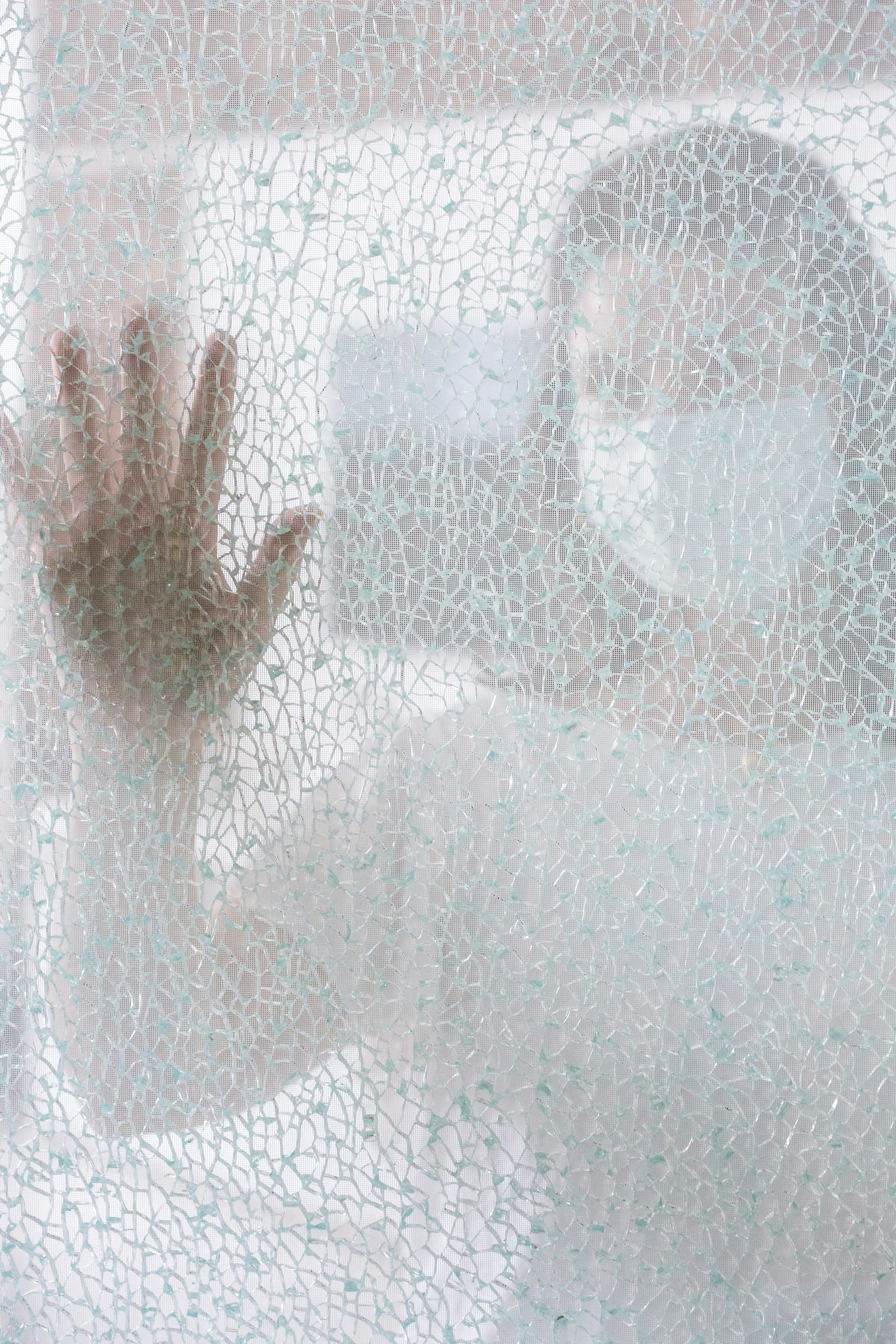 persons hand on glass window