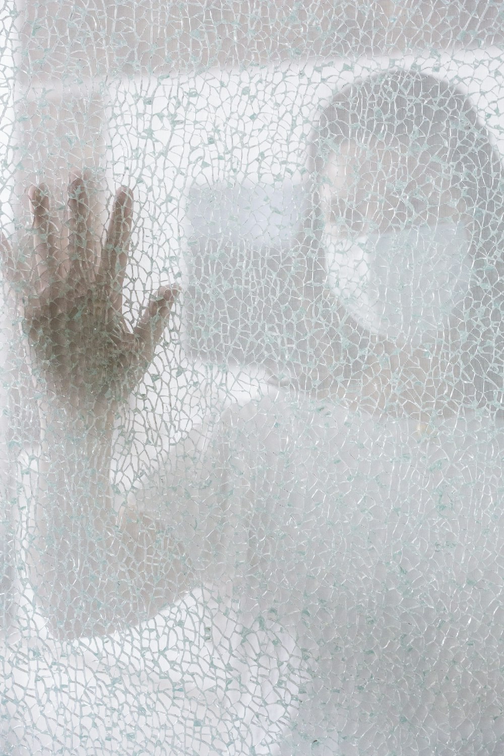 persons hand on glass window