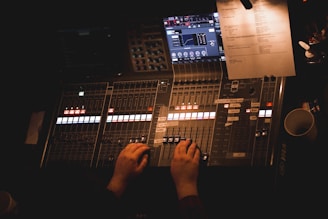 Professional technician testing audio equipment on a mixing console.