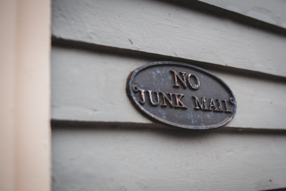 a sign on the side of a building that says no junk mail